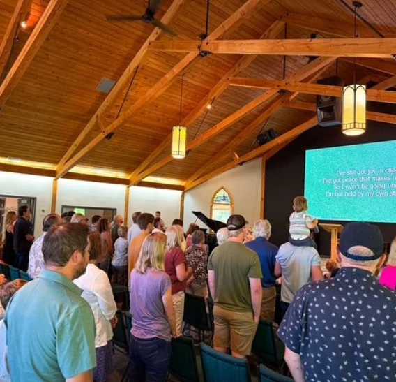 Members of the congregation standing for a church service.